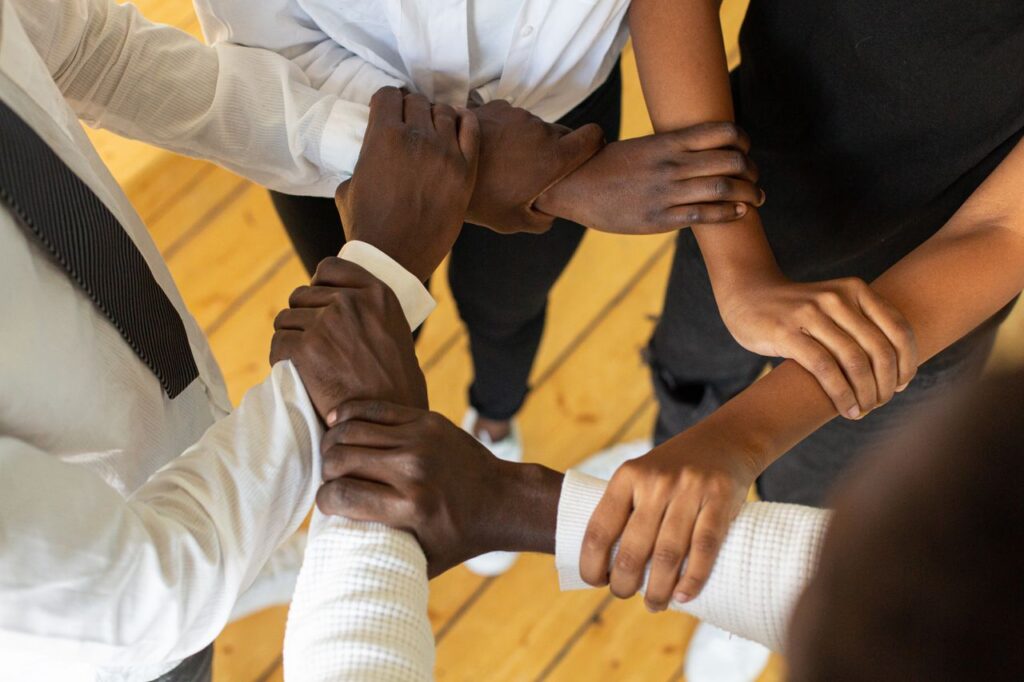 Crafting Captivating Headlines: Your awesome post title goes here Close-up of diverse hands in a circle, symbolizing teamwork and unity.