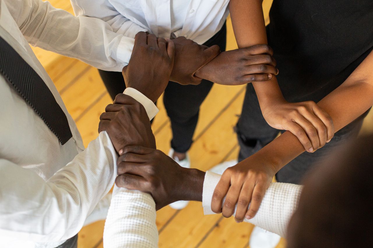 Crafting Captivating Headlines: Your awesome post title goes here Close-up of diverse hands in a circle, symbolizing teamwork and unity.